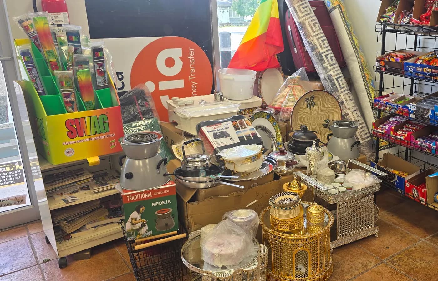 A traditional Ethiopian coffee ceremony set: jebena, cups, and the Ethiopian flag